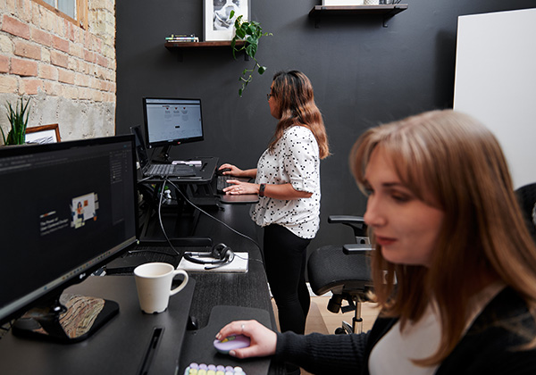 Designers working on their desks in REM's office